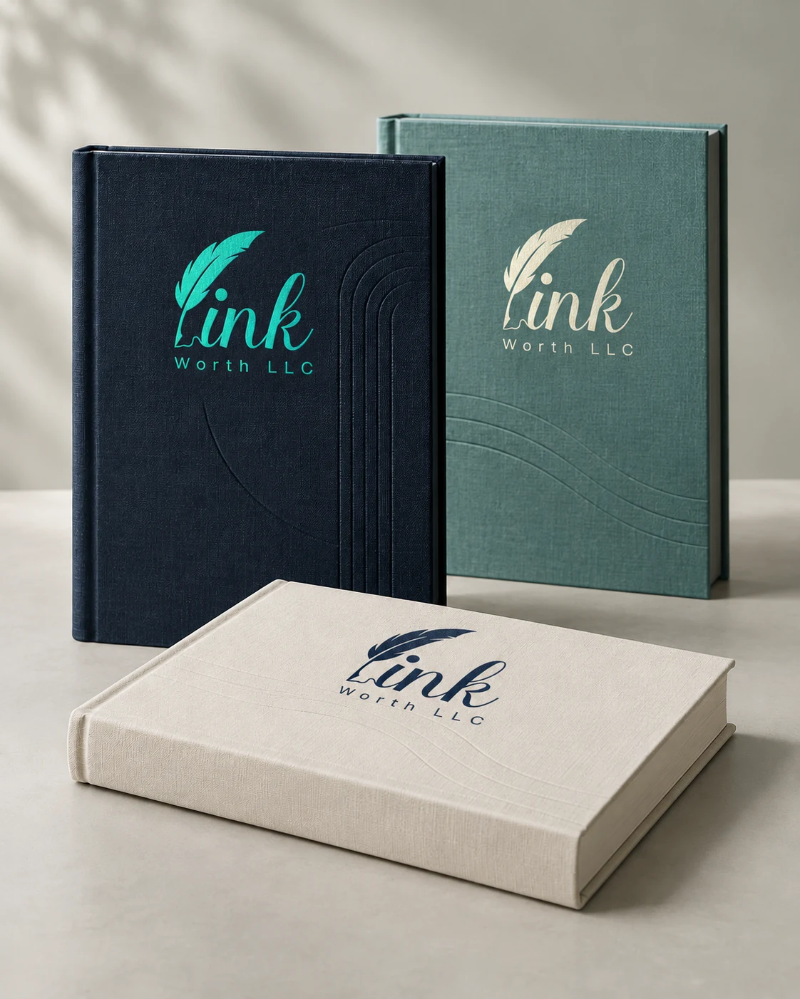 Navy, teal, and ivory clothbound books bearing the Ink Worth LLC logo